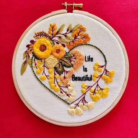 Life Is Beautiful — floral heart with woven wheels and lettering